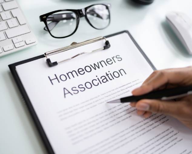 Person Reading HOA Rules And Regulations Document