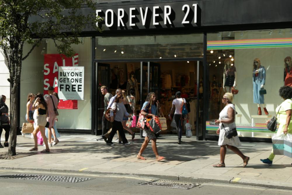 Summer sale season, view of exterior with shoppers walking across the Oxford Street