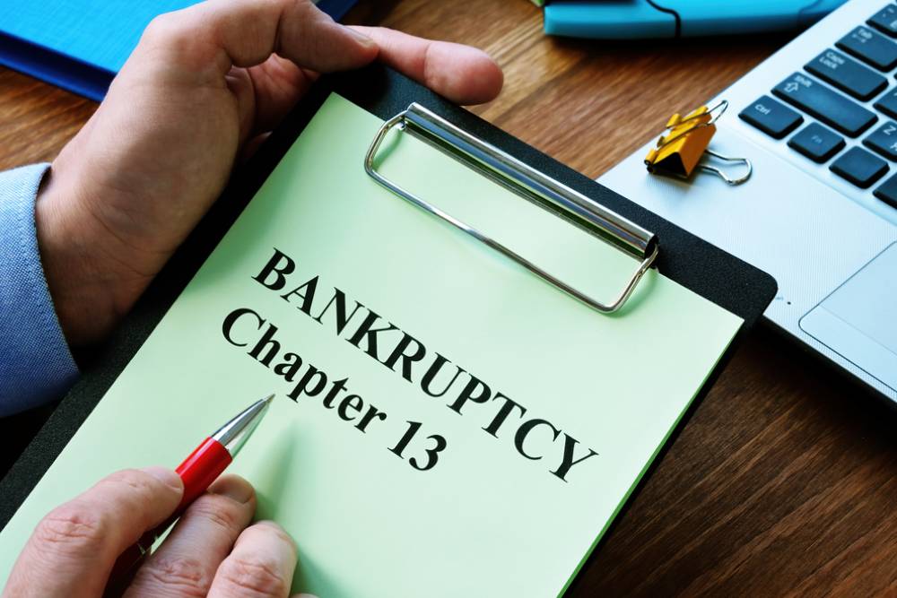 How Does Chapter 13 Bankruptcy Work A Step-by-Step Guide for Florida Residents - Man reads bankruptcy chapter 13 law in the office.